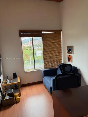 a living room with furniture and a window