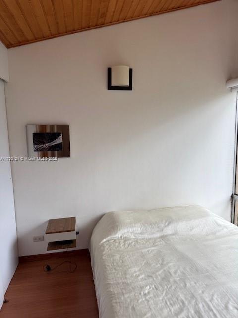 174-8-90 Calle Queens, FL 11101 - Photo 14 of 16 a bedroom with a bed and a couch