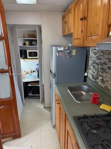 a kitchen with stainless steel appliances granite countertop a sink and a stove