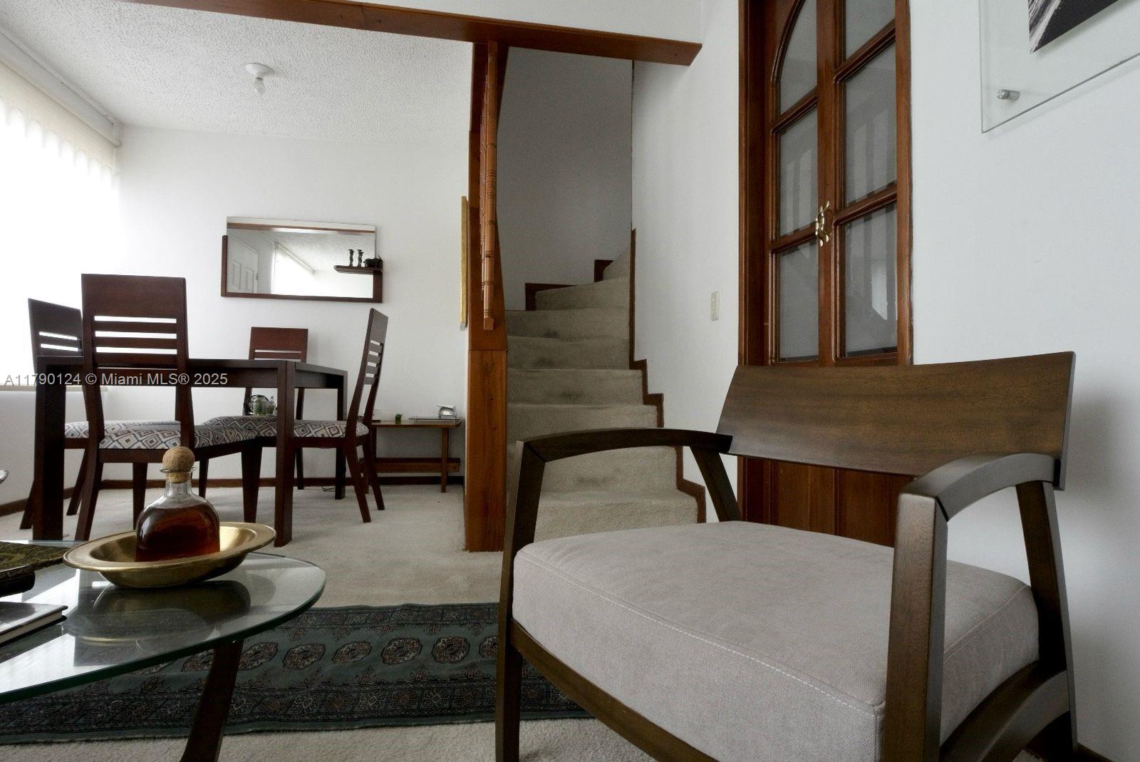 174-8-90 Calle Queens, FL 11101 - Photo 6 of 16 a view of a livingroom with furniture and window