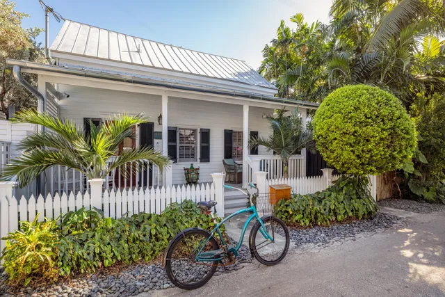 a front view of a house with a porch and furniture