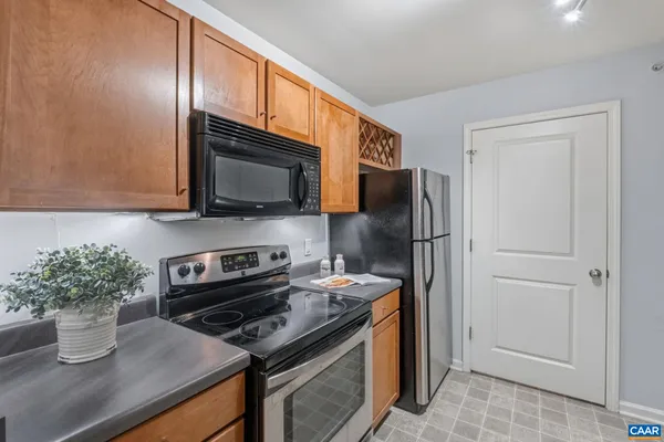 a kitchen with stainless steel appliances granite countertop a refrigerator and a stove top oven
