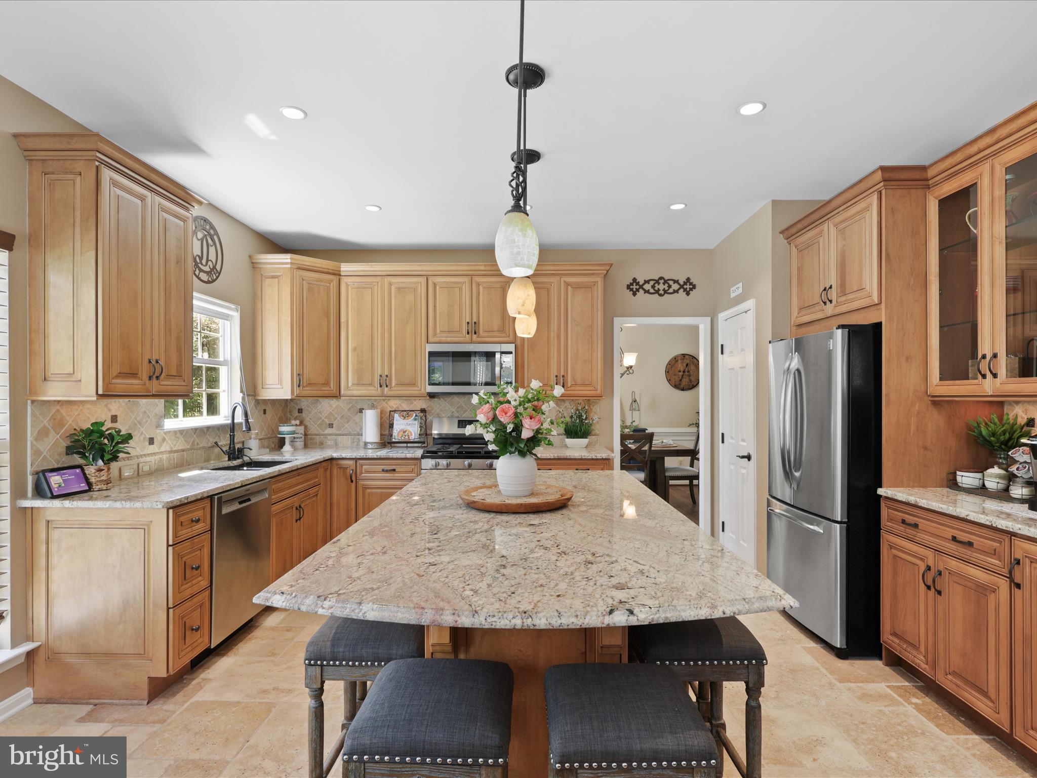 25530 Chilmark Drive Chantilly, VA 20152 - Photo 17 of 67 a kitchen with granite countertop kitchen island stainless steel appliances a sink stove and refrigerator