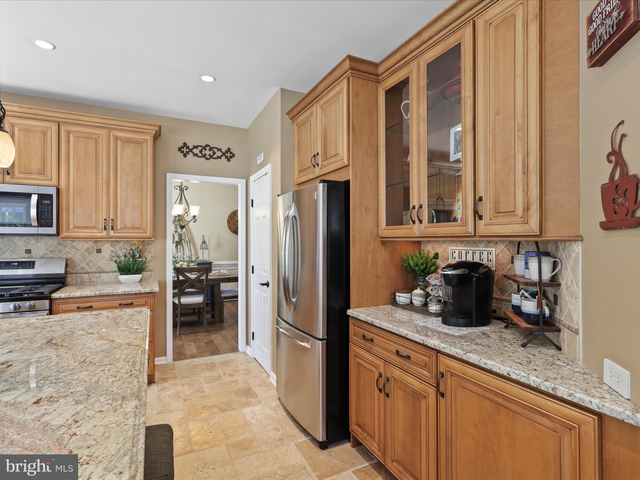 25530 Chilmark Drive Chantilly, VA 20152 - Photo 18 of 67 a kitchen with stainless steel appliances granite countertop a refrigerator and a stove top oven