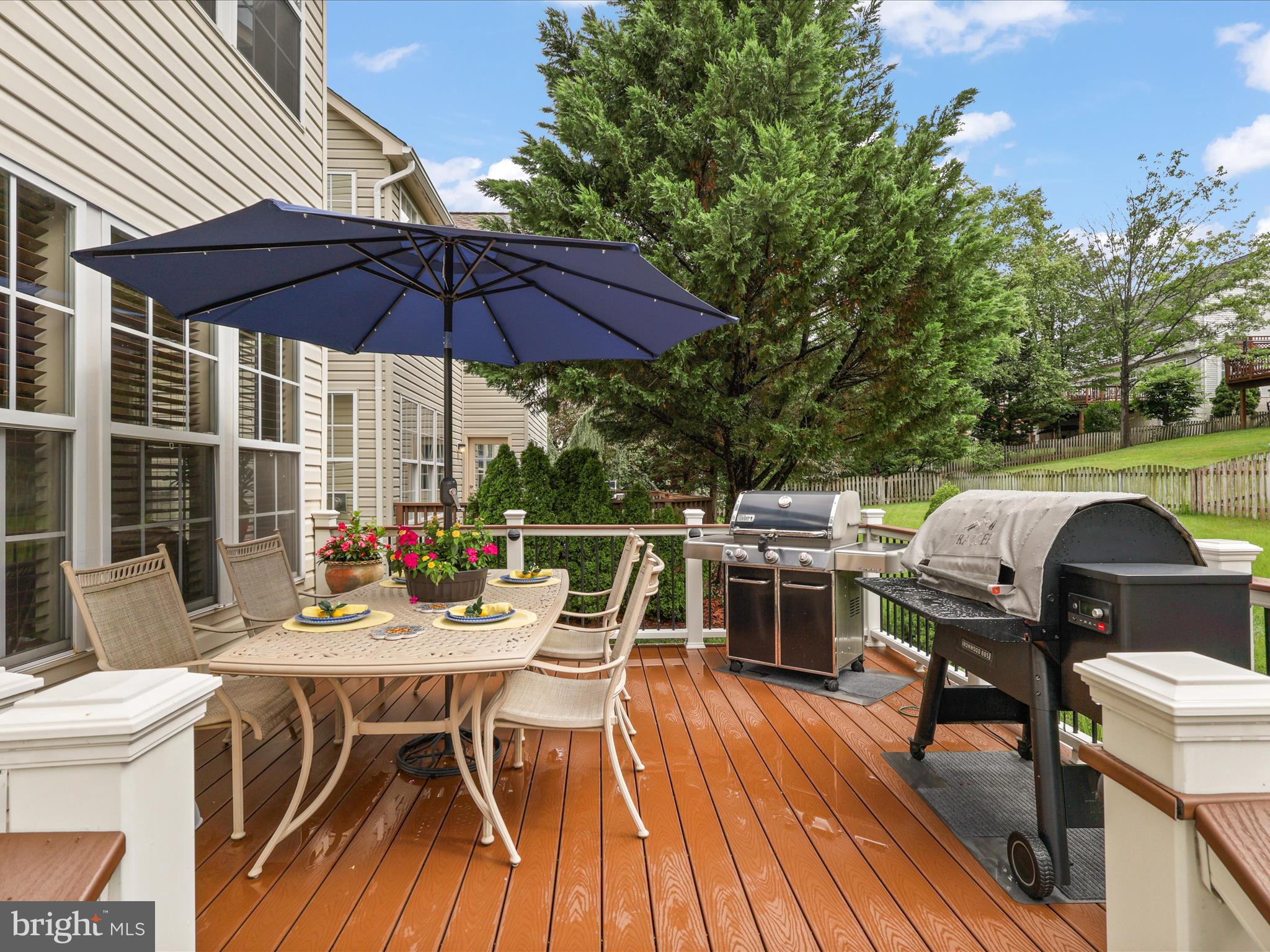 25530 Chilmark Drive Chantilly, VA 20152 - Photo 20 of 67 a view of deck with table and chairs under an umbrella with wooden floor