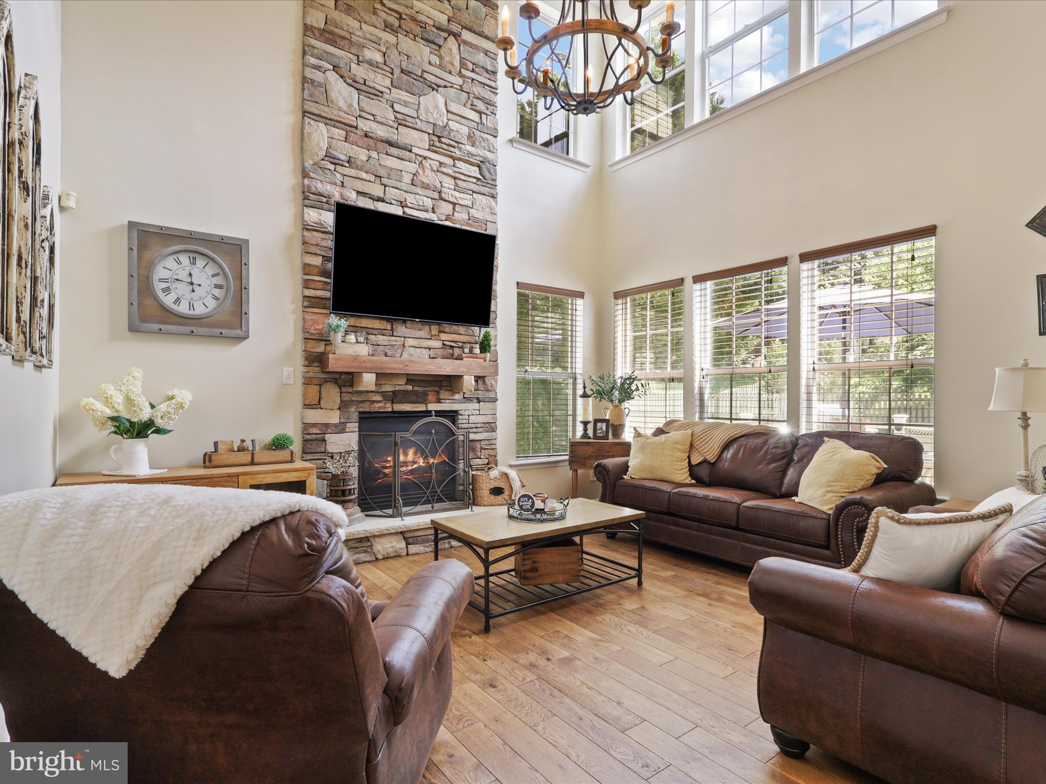 25530 Chilmark Drive Chantilly, VA 20152 - Photo 3 of 67 a living room with furniture a flat screen tv and a fireplace