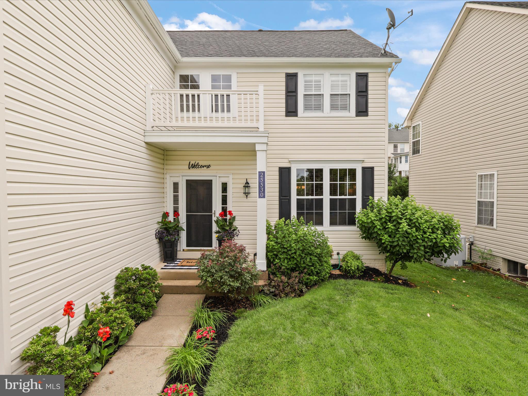 25530 Chilmark Drive Chantilly, VA 20152 - Photo 58 of 67 a front view of a house with a yard and potted plants