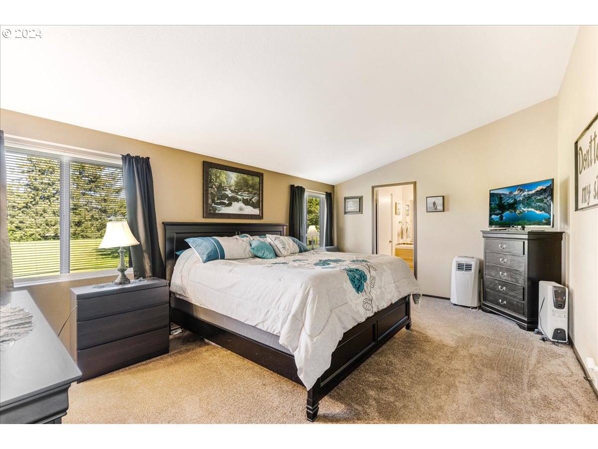 25970 South Wallens Road Estacada, OR 97023 - Photo 12 of 48 a bedroom with a large bed and a large window