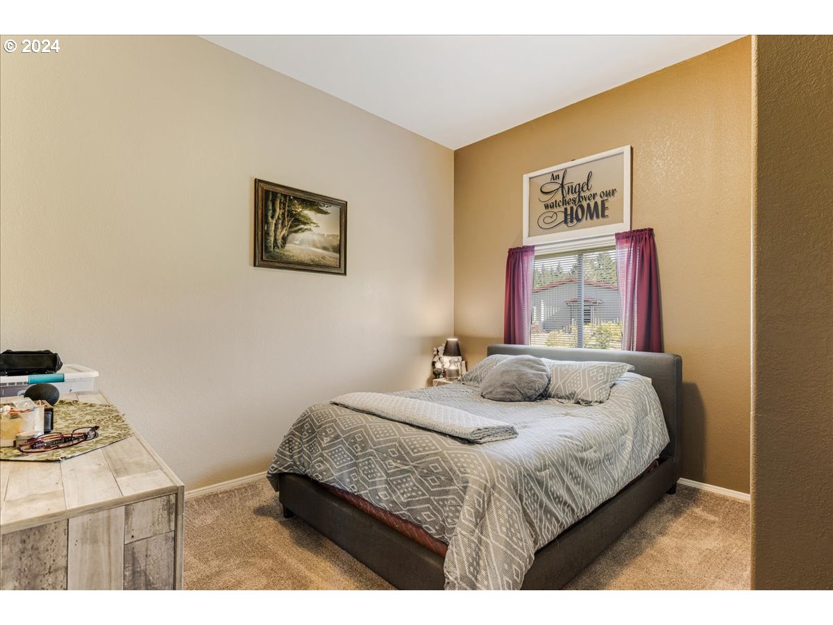 25970 South Wallens Road Estacada, OR 97023 - Photo 14 of 48 a bedroom with a bed and a desk