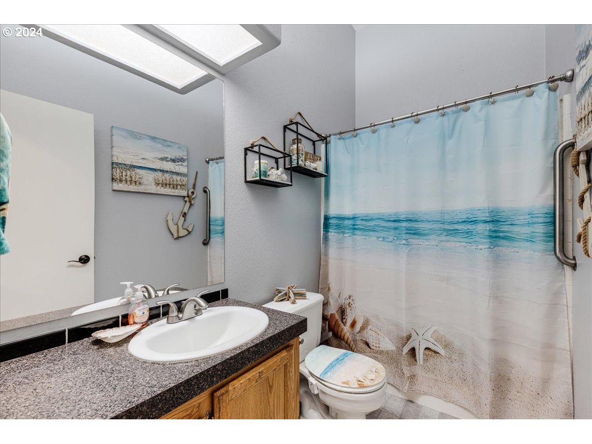 25970 South Wallens Road Estacada, OR 97023 - Photo 16 of 48 a bathroom with a sink and mirror with toilet