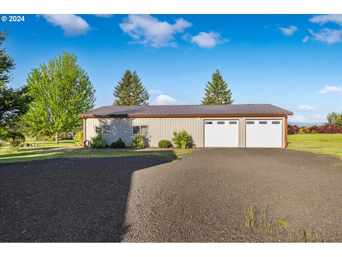 25970 South Wallens Road Estacada, OR 97023 - Photo 19 of 48 a view of a big room with a large window and a yard