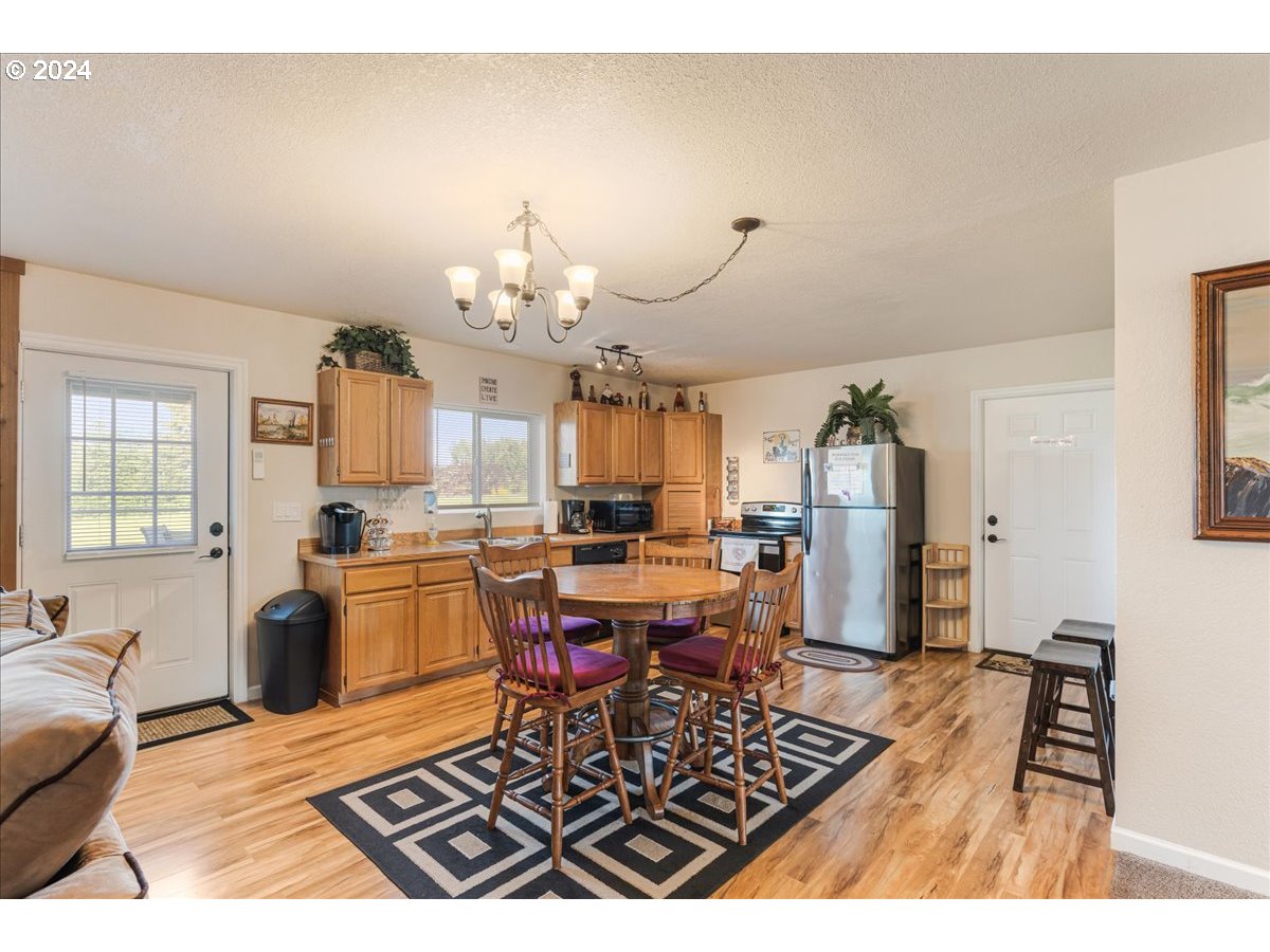 25970 South Wallens Road Estacada, OR 97023 - Photo 24 of 48 a living room with furniture a chandelier and a dining table