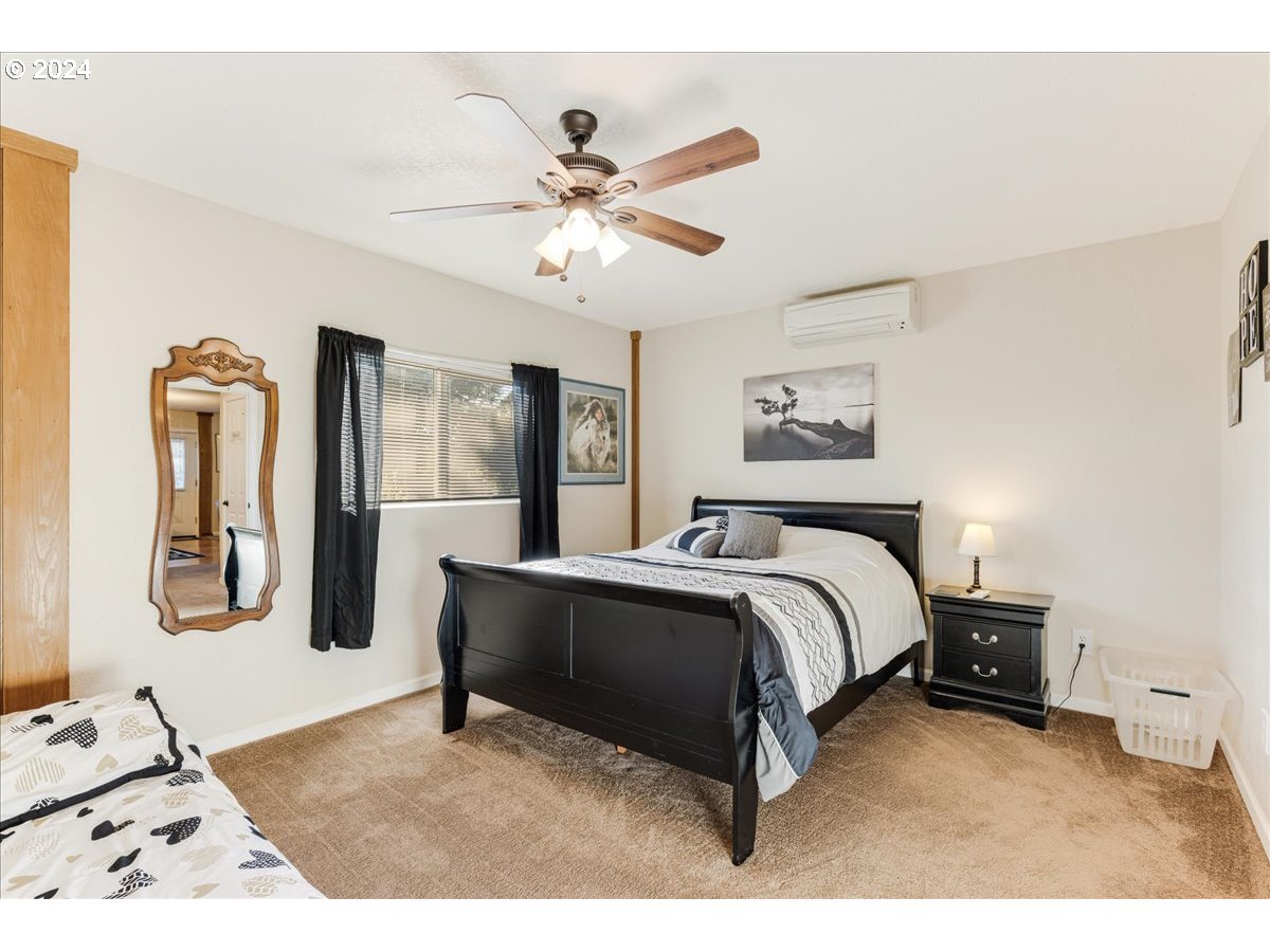 25970 South Wallens Road Estacada, OR 97023 - Photo 25 of 48 a bedroom with a bed lamp and dresser