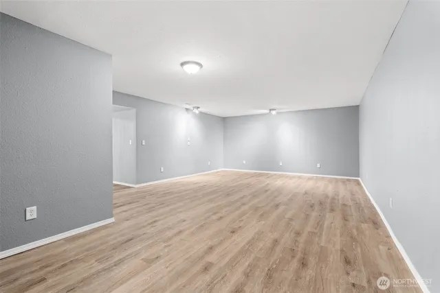 a spacious bedroom with a large bed and a dresser