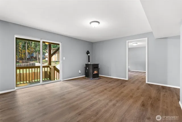 a view of a backyard with potted plants and wooden fence