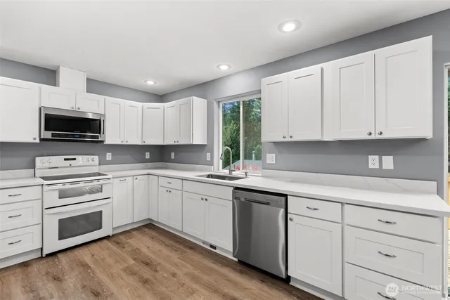 a view of an empty room with a ceiling fan and a window