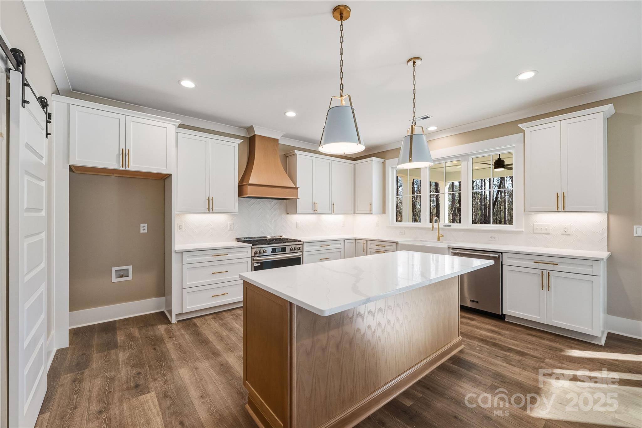 1913 Snyders Store Road, Unit 5 Wingate, NC 28174 - Photo 11 of 48 a kitchen with stainless steel appliances granite countertop a stove a sink a refrigerator and island with wooden floor