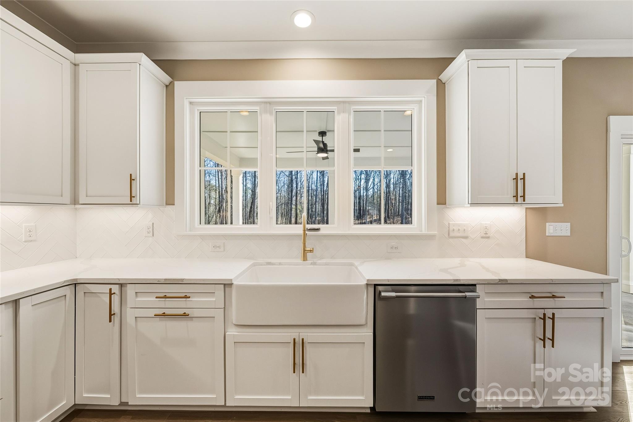 1913 Snyders Store Road, Unit 5 Wingate, NC 28174 - Photo 15 of 48 a kitchen with stainless steel appliances cabinets a large window and a sink