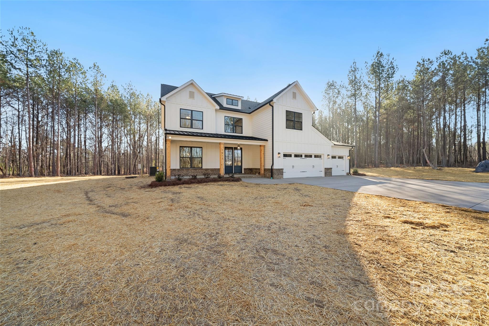 1913 Snyders Store Road, Unit 5 Wingate, NC 28174 - Photo 2 of 48 a view of a white house with a yard covered with snow