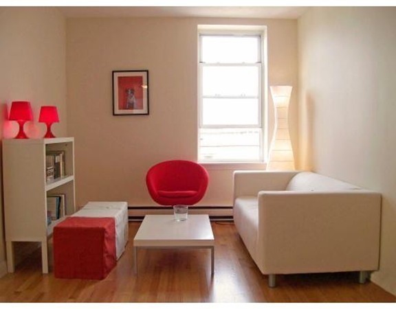 160 Cottage Street, Unit 302 Boston, MA 02128 - Photo 6 of 18 a living room with furniture a window and a lamp