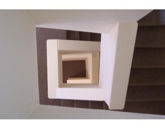 160 Cottage Street, Unit 302 Boston, MA 02128 - Photo 7 of 18 a hallway with wooden floor a fireplace and a microwave