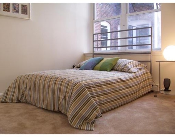 160 Cottage Street, Unit 302 Boston, MA 02128 - Photo 8 of 18 a bedroom with a bed and a window