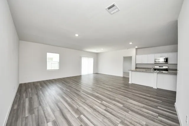 a view of kitchen with sink and wooden floor