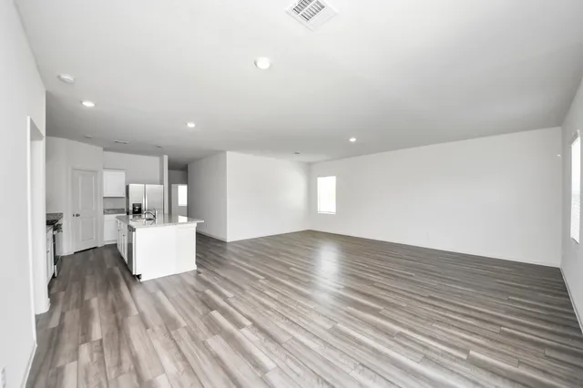 a view of kitchen and hall with wooden floor