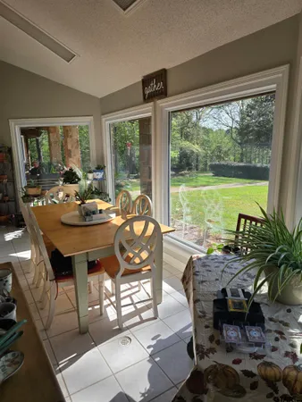 a view of a workspace with furniture and a window