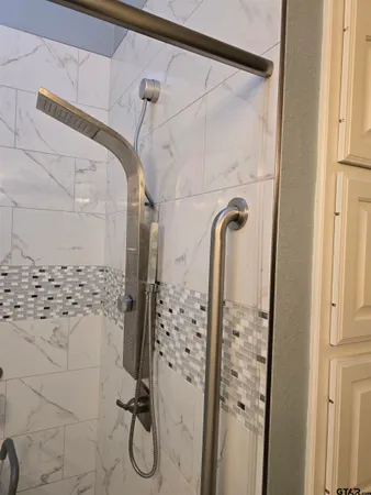 a bathroom with a toilet and a shower