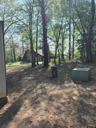 a kitchen with a chandelier a dining table and chairs