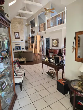 a dining room with furniture and a floor to ceiling window