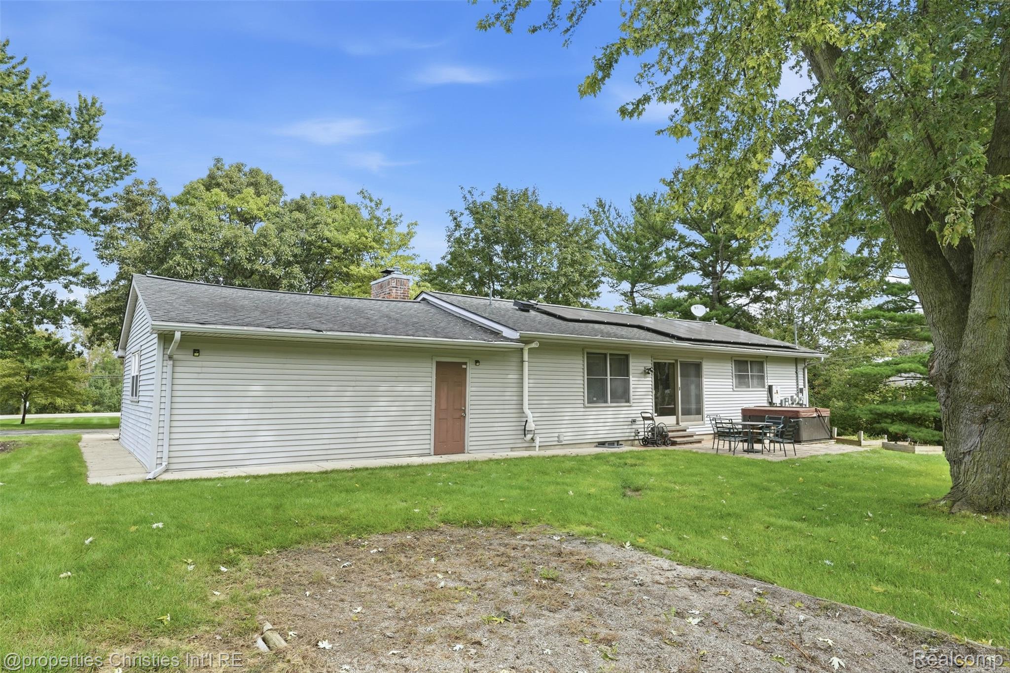 4030 Textile Road Ypsilanti, MI 48197 - Photo 42 of 58 Exterior features include siding, a patio area, and mature trees