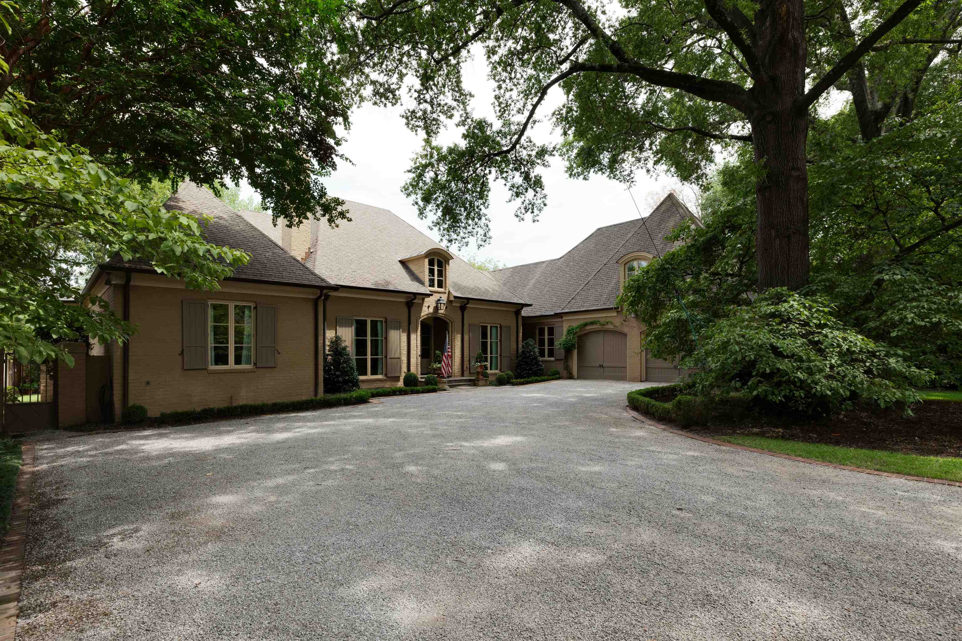 a front view of a house with a garden