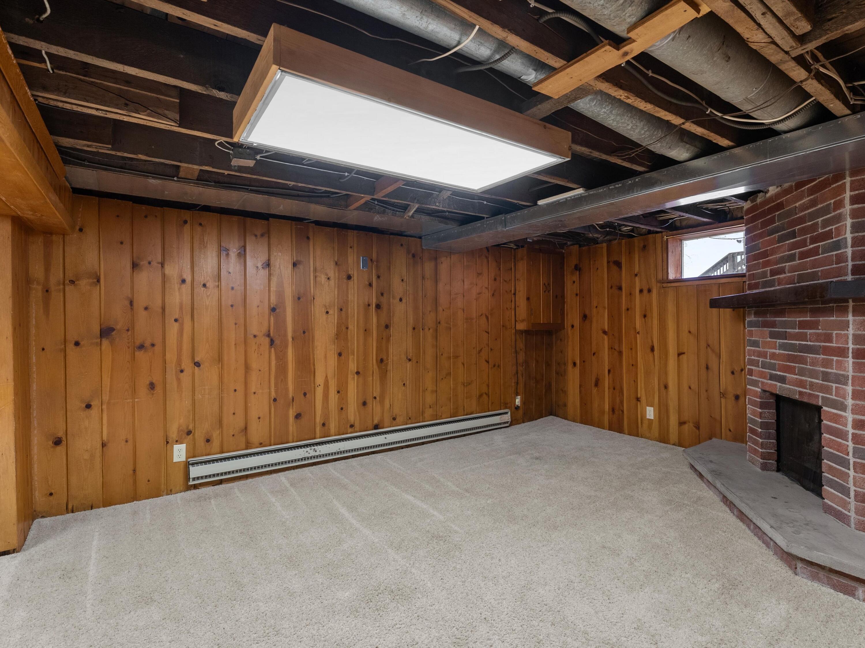 2323 9th Place Two Rivers, WI 54241 - Photo 26 of 35 Finished portion of the basement with a natural fireplace