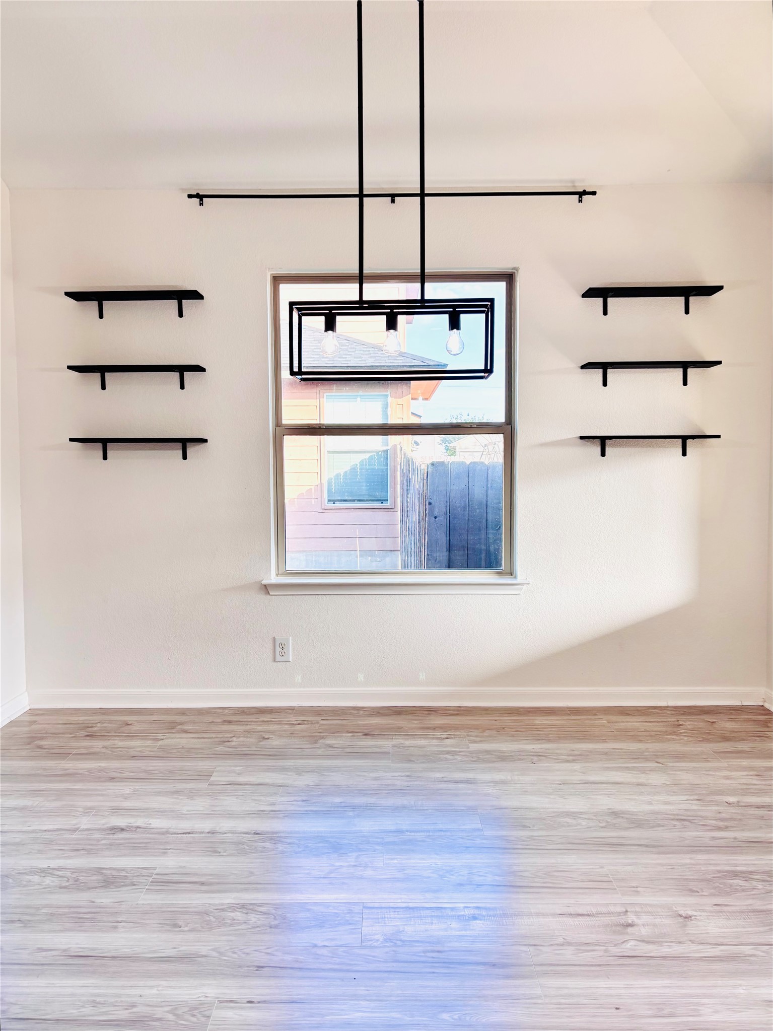 606 Old Peak Road Georgetown, TX 78626 - Photo 13 of 23 A well-lit room featuring contemporary shelving and sleek wood flooring, ready for personalization.