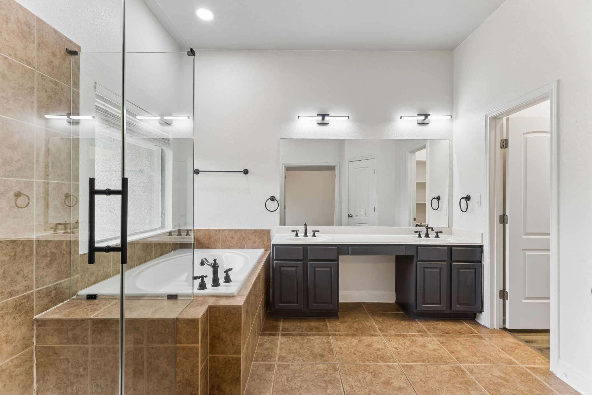 114 Aria Ridge, Unit 802 Lakeway, TX 78738 - Photo 25 of 37 Luxurious primary bathroom features a spacious soaking tub, separate shower, and dual vanities.