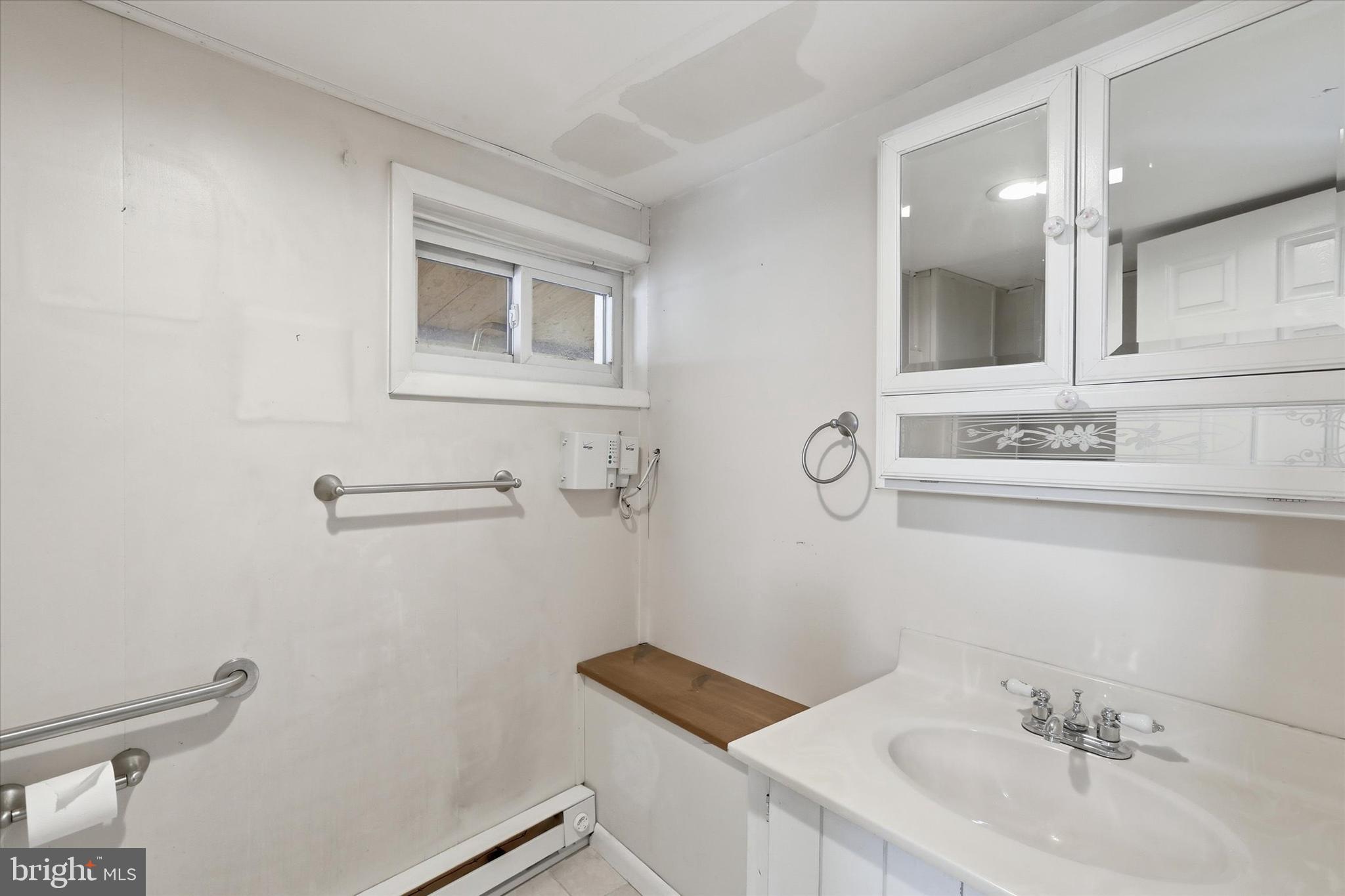 337 Main Street Tullytown, PA 19007 - Photo 11 of 33 a bathroom with a sink and a mirror