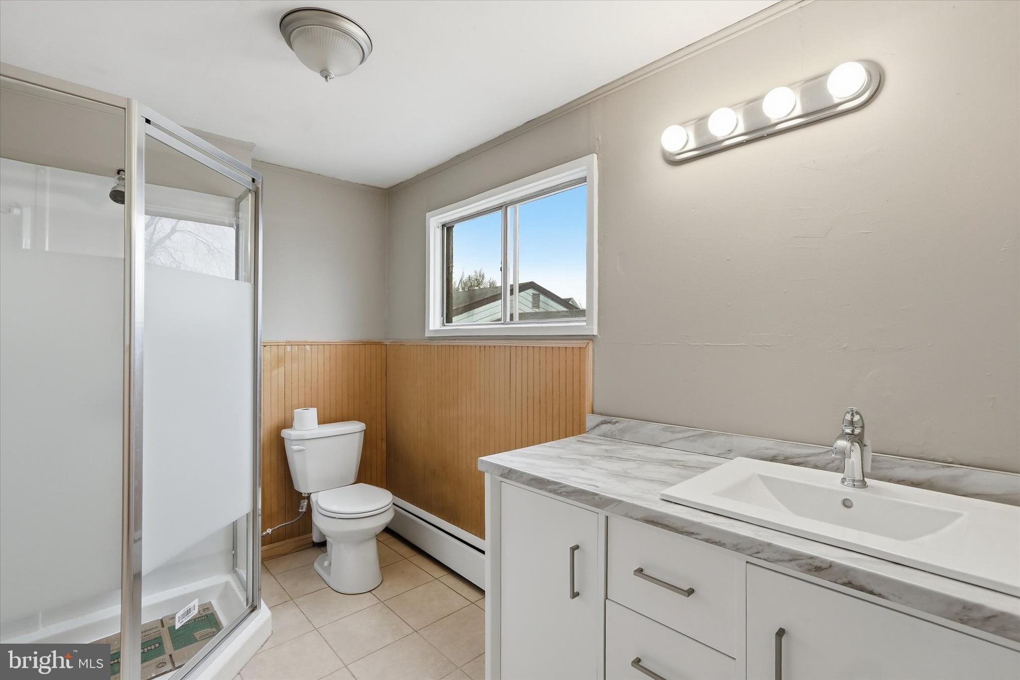 337 Main Street Tullytown, PA 19007 - Photo 27 of 33 a bathroom with a granite countertop sink mirror vanity and toilet