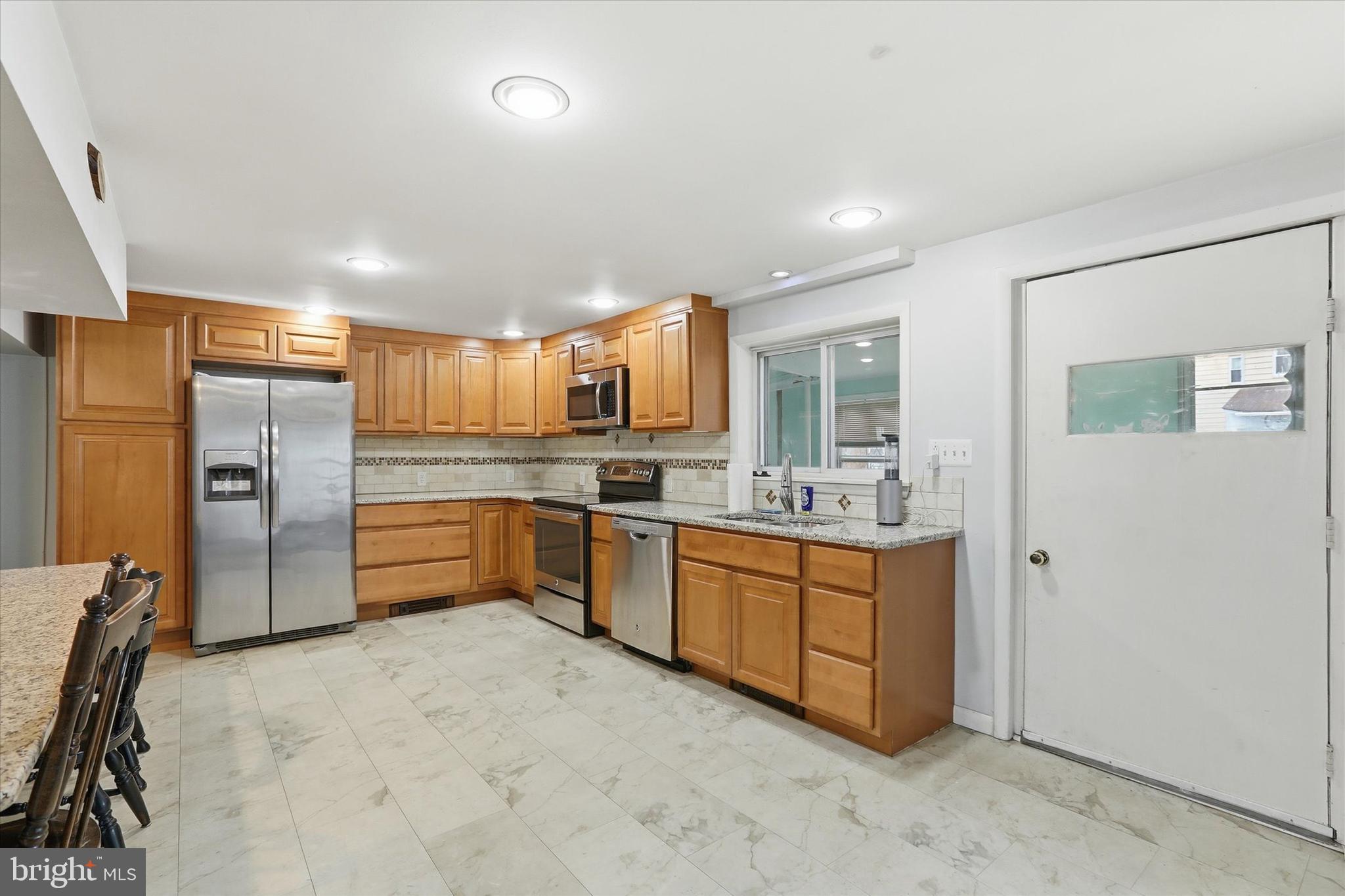 337 Main Street Tullytown, PA 19007 - Photo 8 of 33 a room with stainless steel appliances kitchen island granite countertop a refrigerator and a stove top oven