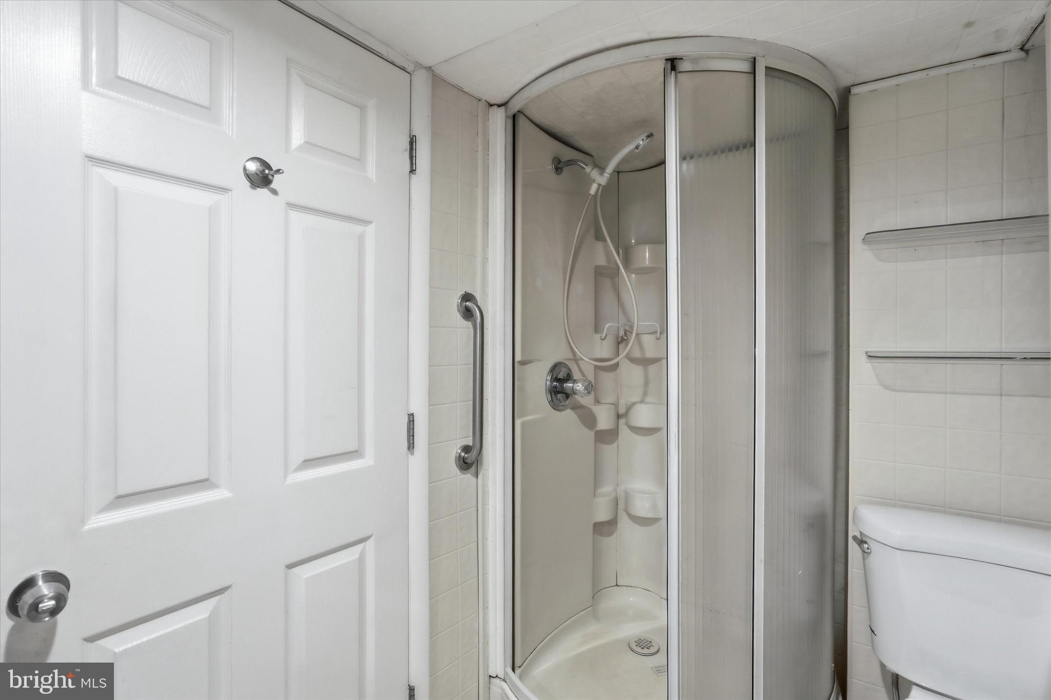 337 Main Street Tullytown, PA 19007 - Photo 10 of 33 a bathroom with a glass shower door