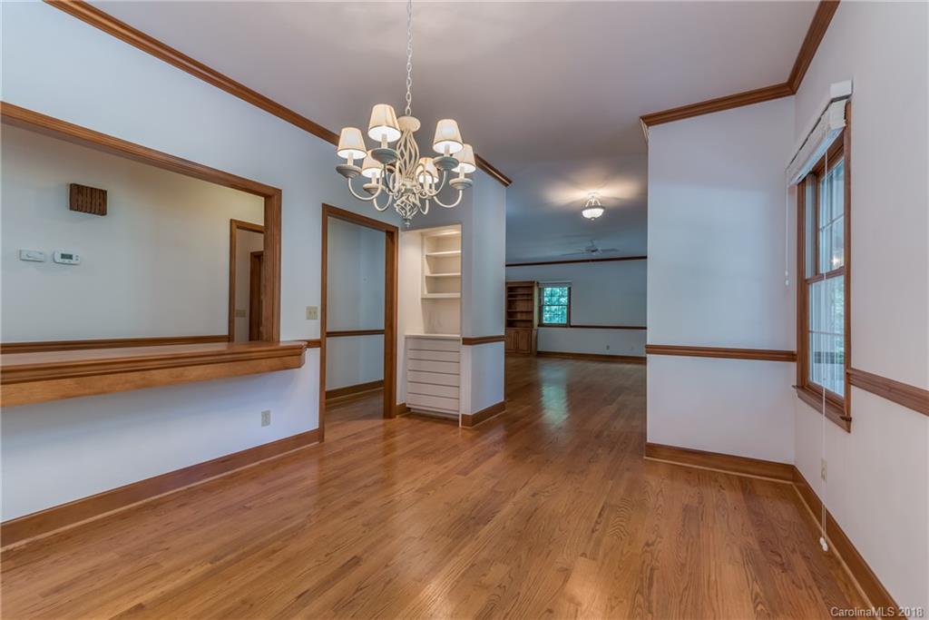 661 Henderson Road Tryon, NC 28782 - Photo 12 of 33 a view of a livingroom with wooden floor and a kitchen space