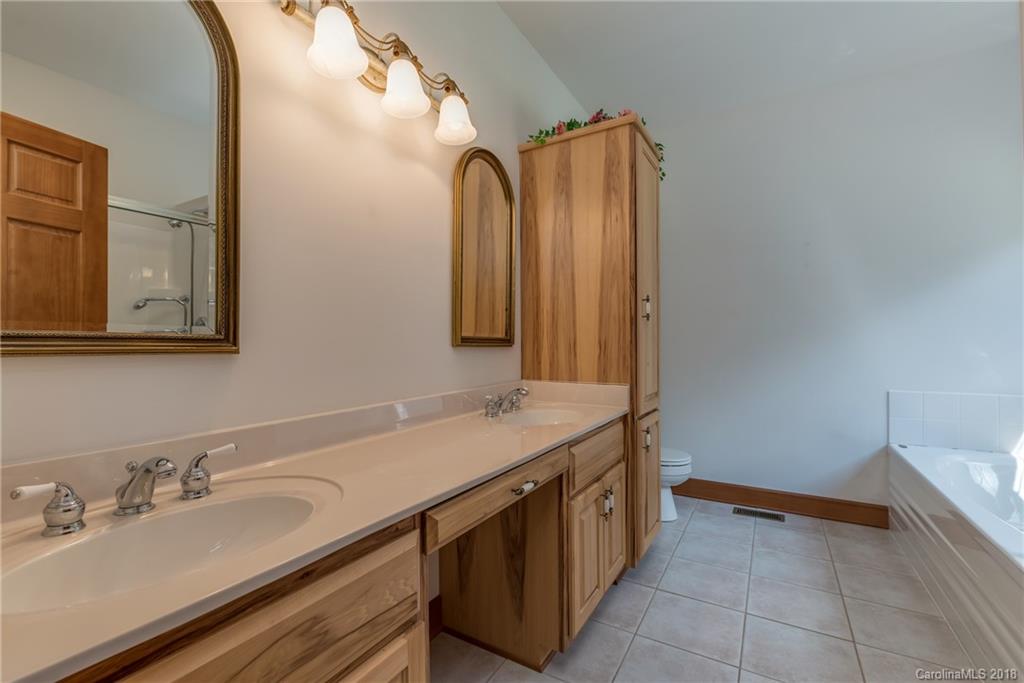661 Henderson Road Tryon, NC 28782 - Photo 15 of 33 a bathroom with a sink and a mirror