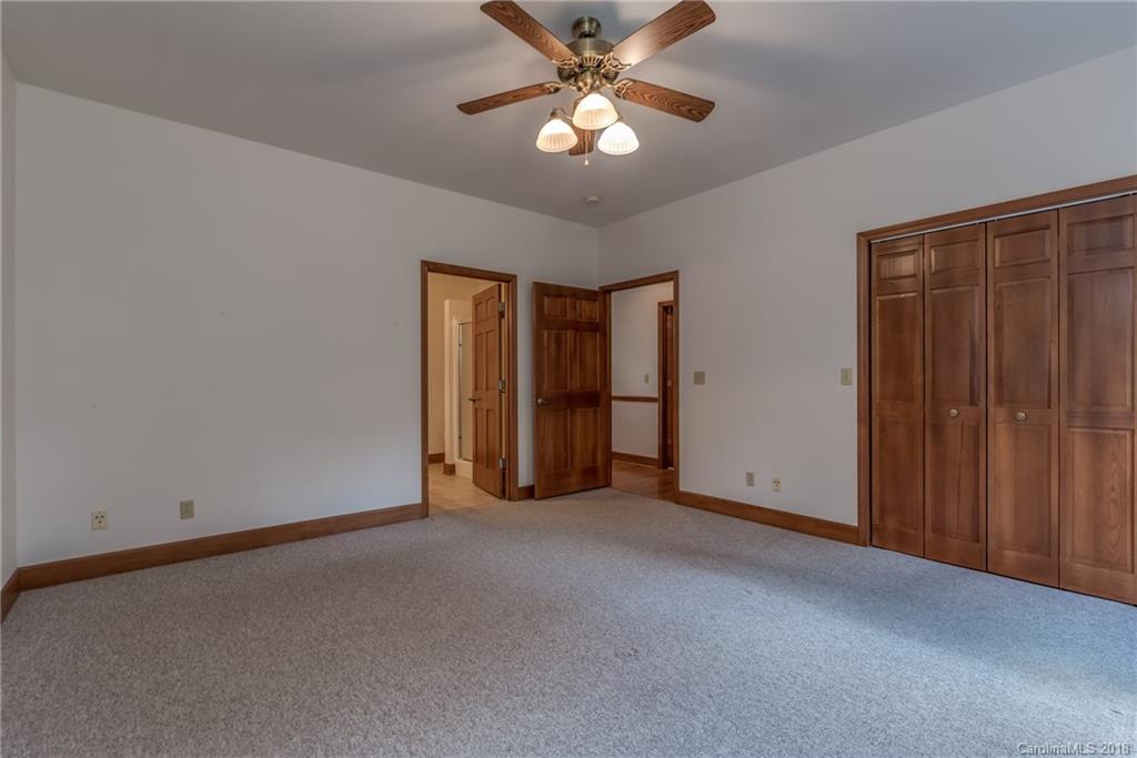 661 Henderson Road Tryon, NC 28782 - Photo 18 of 33 a view of an empty room with a ceiling fan