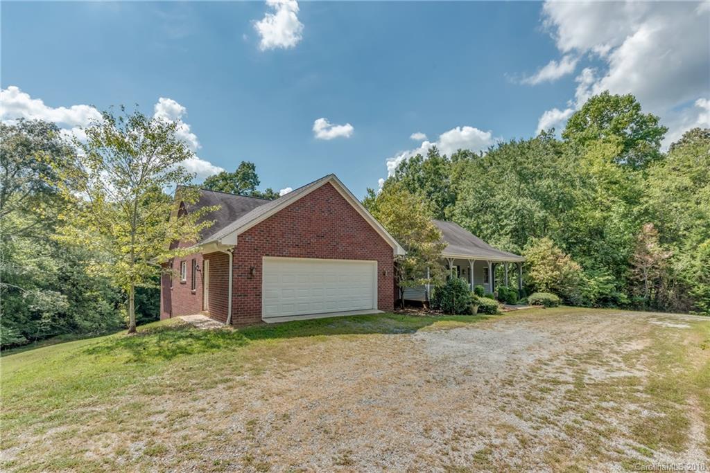 661 Henderson Road Tryon, NC 28782 - Photo 3 of 33 a front view of a house with a yard and garage