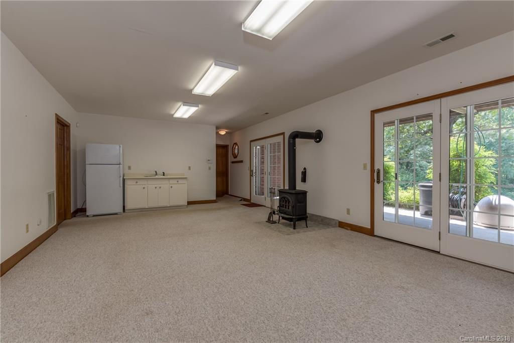 661 Henderson Road Tryon, NC 28782 - Photo 21 of 33 an empty room with furniture and a large window