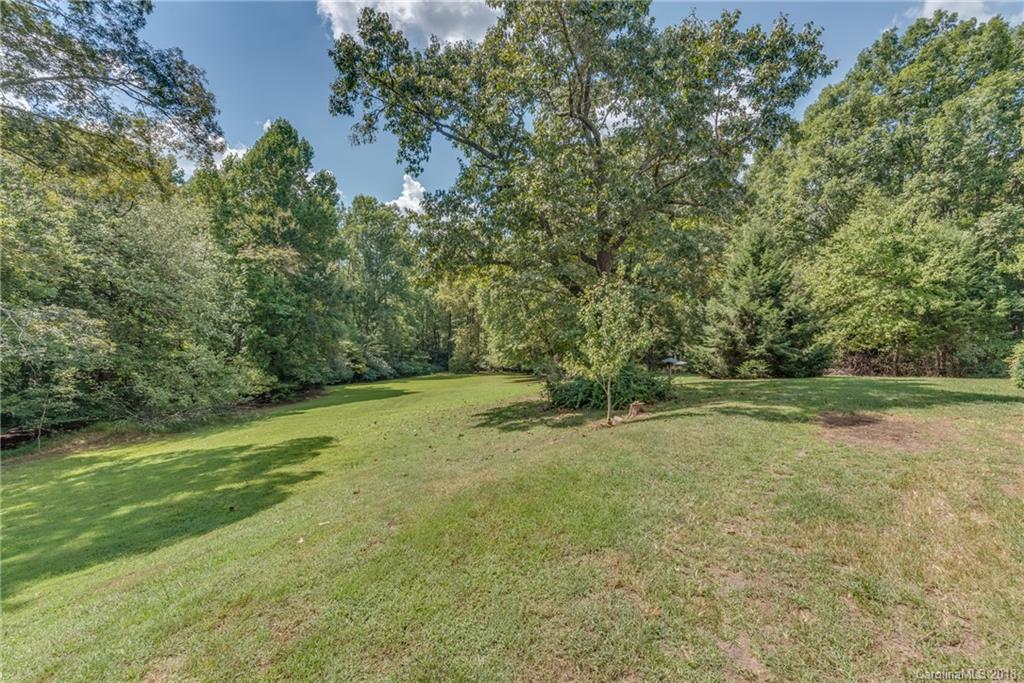 661 Henderson Road Tryon, NC 28782 - Photo 28 of 33 a view of a field with trees in the background