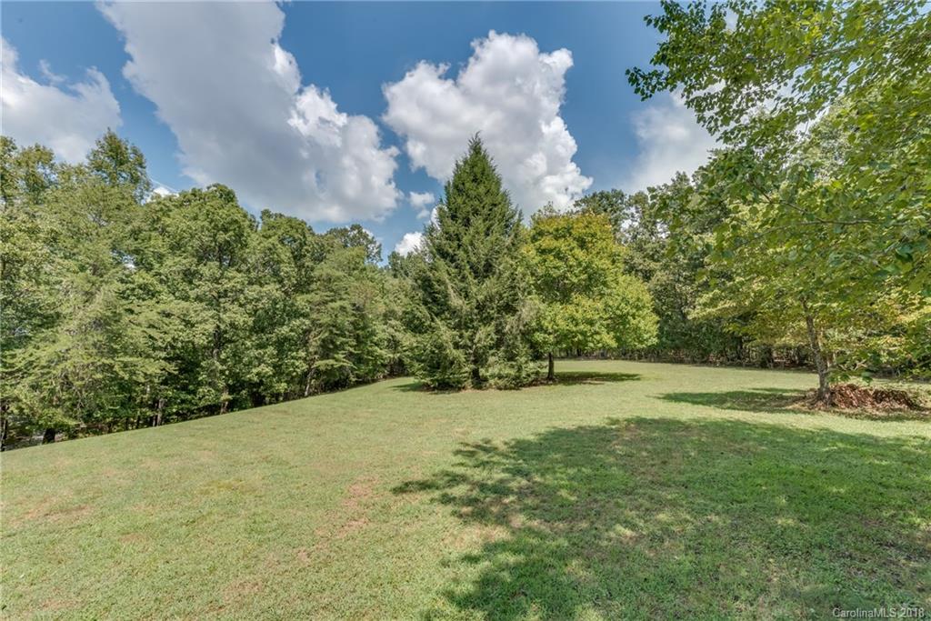 661 Henderson Road Tryon, NC 28782 - Photo 29 of 33 a backyard of a house with lots of green space