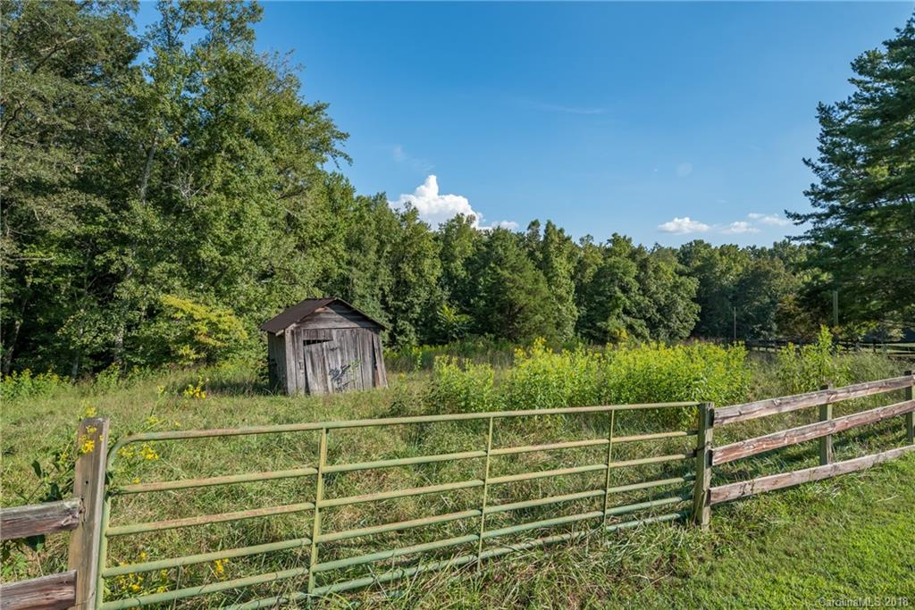 661 Henderson Road Tryon, NC 28782 - Photo 32 of 33 a view of a field with wooden fence