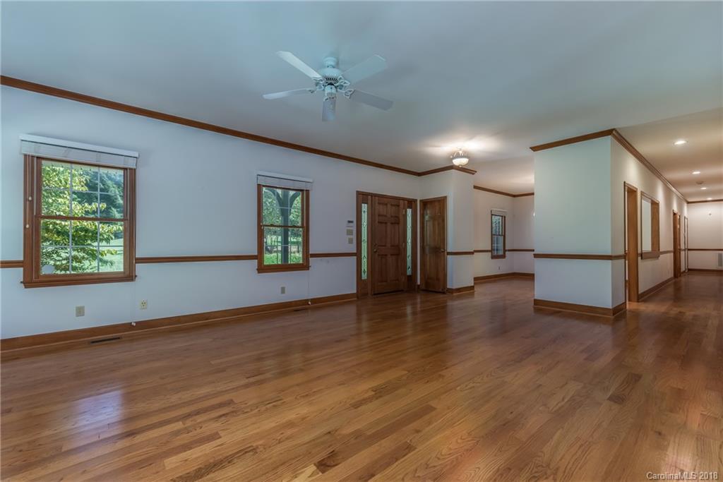 661 Henderson Road Tryon, NC 28782 - Photo 6 of 33 a view of empty room with wooden floor and fan